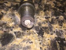 Thought a on the plug ?? All 4 are similar to this, they have around 20k miles .You can't tell from the picture but it's sort of grayish grainy looking