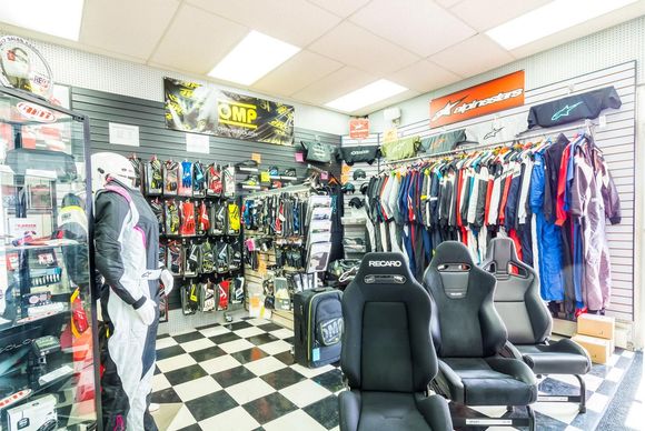 Stable Energies retail store. Here is our driver apparel section. Customers are able to try on Driving Suits from Alpinestars & OMP. As well as gloves and driving shoes.