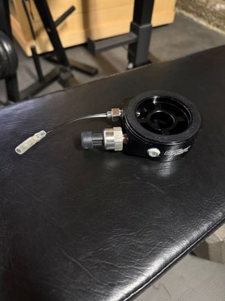 The sandwich plate adapter with the fittings installed using permatex liquid. Glowshift recommends teflon tape because it’s easier to remove the fittings if needed. I opted for permatex as others online had problems with teflon tape. 