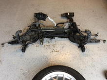 Replacing hoses, clearing out axel grease/coolant/PS fluid &amp; years of dirt off the sub frame assembly (Before).