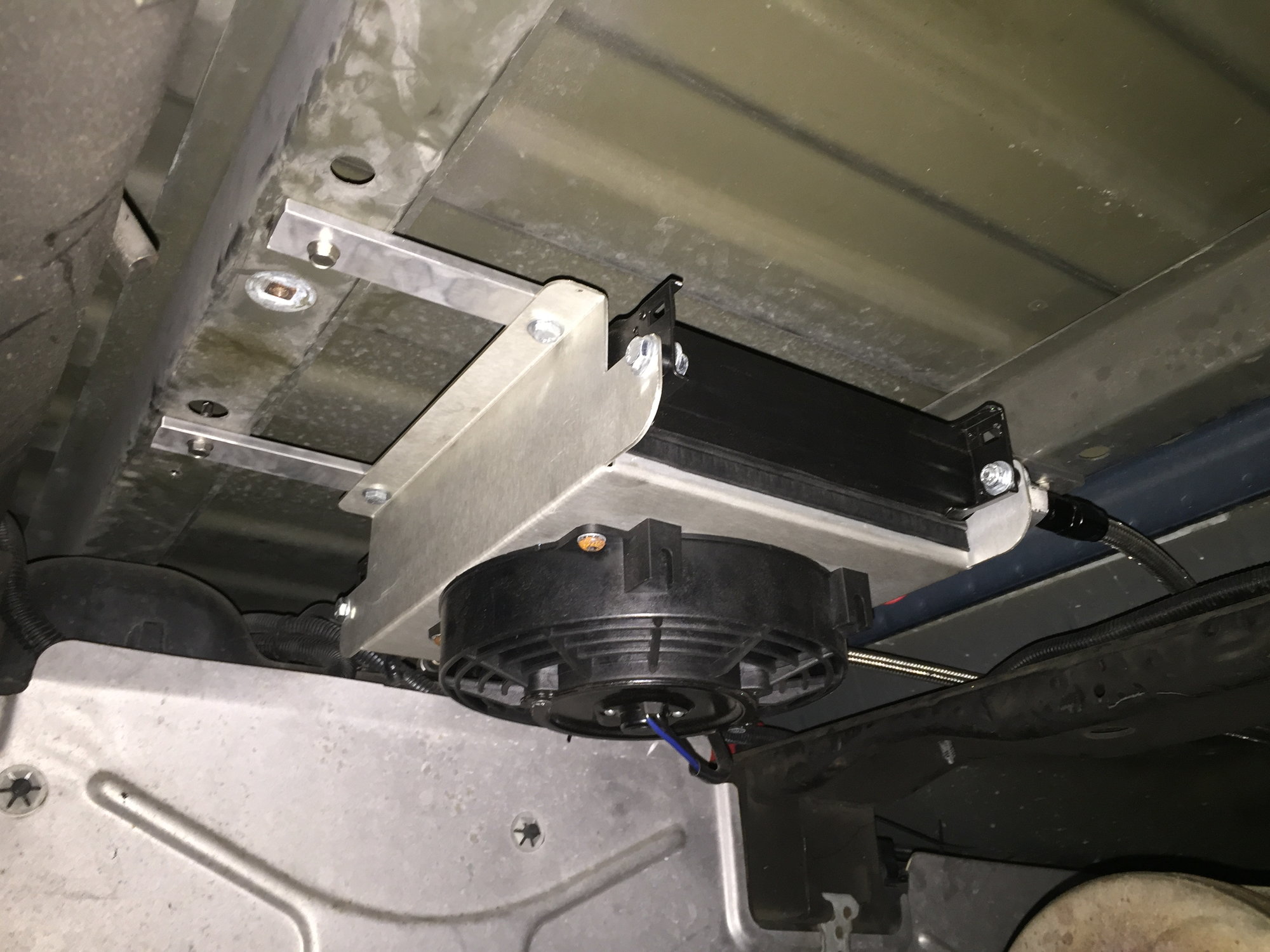 Cooler mounting under car transmission 