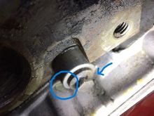 The circle shows the leak and the arrow indicates that coolant comes aroung on the housing.