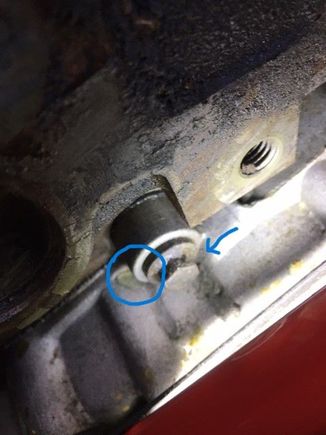 The circle shows the leak and the arrow indicates that coolant comes aroung on the housing.