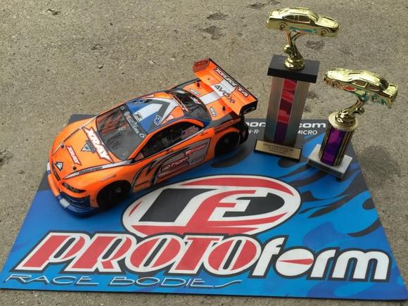 My Xray and its Invitational trophies!  I'm running an ORCA TX 17.5, Orion R10 Pro US Stock Spec ESC, Savox 1252 low-profile servo, Reedy 5500 60C lipo, Protoform Mazda Speed6 body, and Contact RC foam tires.  Controlled by a KO Propo EX1-KIY