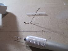 regular sewing pins will be used to hold the tube in place as well as look like the filament inside the tube.  I  clipped two pins to length, and inserted a small amount of epoxy inside each end on the plastic tube.