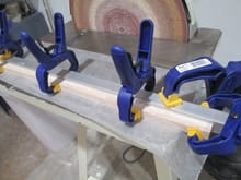 The key to getting a nice and straight spar is to make sure that they are clamped using something that is straight and flat.