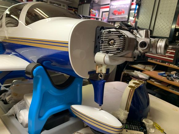 Mike,
Here is a picture of the muffler header connected to my OS 75 FX 2 stroke. Waiting for the in cowl muffler from tower. They still sell the muffler but not the header pipe. 
Jim