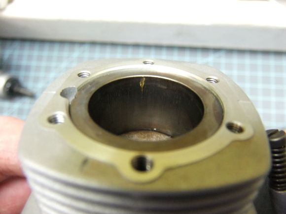 This is the cylinder on the engine with the red fuel line with the small flake on the liner. Still was running good and has good compression.