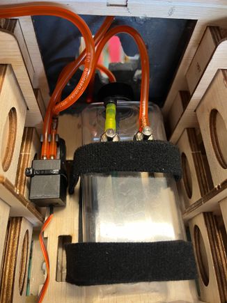 Pump to the left of the tank.  Simple and effective.