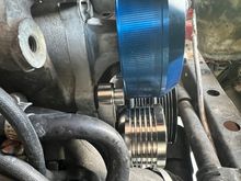 On the pulley bracket There is a little space where the stud goes into the water pump.  
I wanted to let it sit flush so I added a washer.  Used the supplied long bolt (to replace the stock stud and nut) but as you can see the bolt head is hitting touching the water pump pulley (blue)…