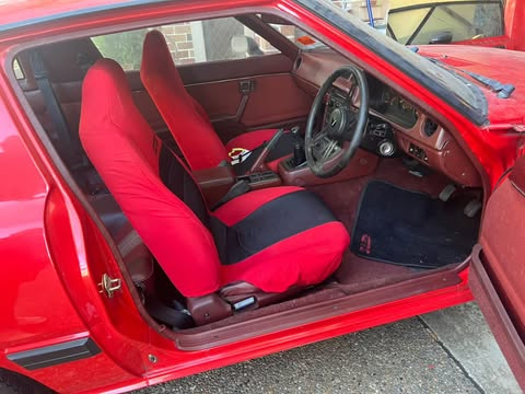 The burgundy interior of the coupe is in excellent condition.  The Series 2 interiors were always very good.  The seats under the covers are in excellent condition.