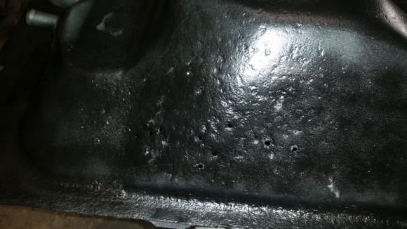 Sanded the gas tank to clean it up and paint, I put down a coat of etch primer and found several pin holes, this one whole area is pitted pretty bad. Debating whether or not to patch it