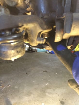 Remove the other lower shock mounting bolt with a 17 mm wrench.