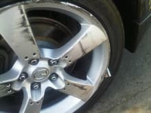 Was parked on the side of the road and over night was hit by some car.. that is a piece of the other cars rim.. the other pieces were on the street. not sure how it happened the other car was never found