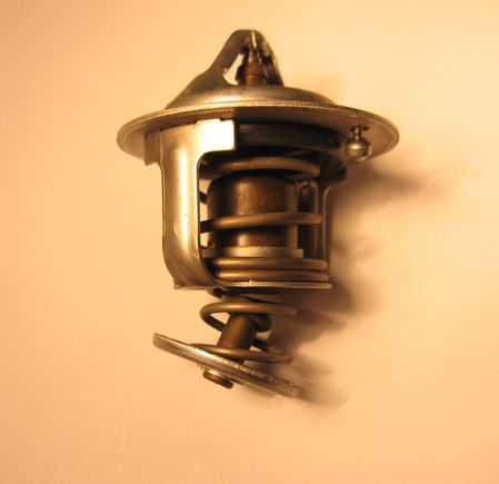 Thermostat removed from 2005 AT RX8. Metal failure. Car was not symptomatic while this was in operation. It was discovered during routine maintenance.