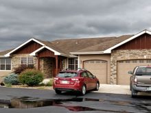 Front of house with 3 car attached garage.