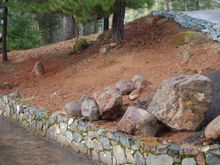 Boulders and new stone work at lower edge of top driveway.
