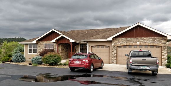 Front of house with 3 car attached garage.