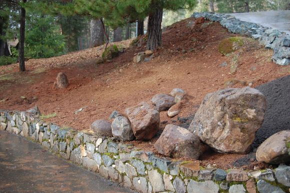 Boulders and new stone work at lower edge of top driveway.