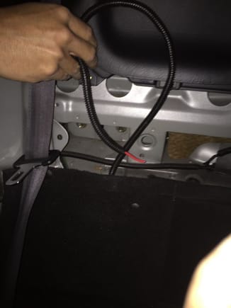 This is the power wire ready to go into the trunk from behind the passenger seat.