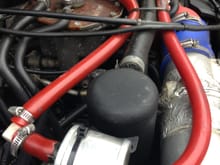 pic of the two catch cans, red pipes- heads, runs back to the turbo inlet. Black catch can which has drain plug at bottom, both have internal gauzing