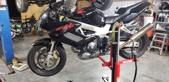 Just gonna throw this out here i picked up an abba skylift  i have 2 garages and at one i have the good ole harbor fright special bench type and nust recently i picked this up mostly for my vtr by i have the adapters for all of my bikes also have the attachment to remove the swingarm big thanks to those rear foot pegs