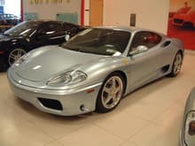 2004 360 Modena F1; Grigio Alloy with Blu Scuro leather, front and rear Challenge grilles, modular wheels, shields, red calipers.