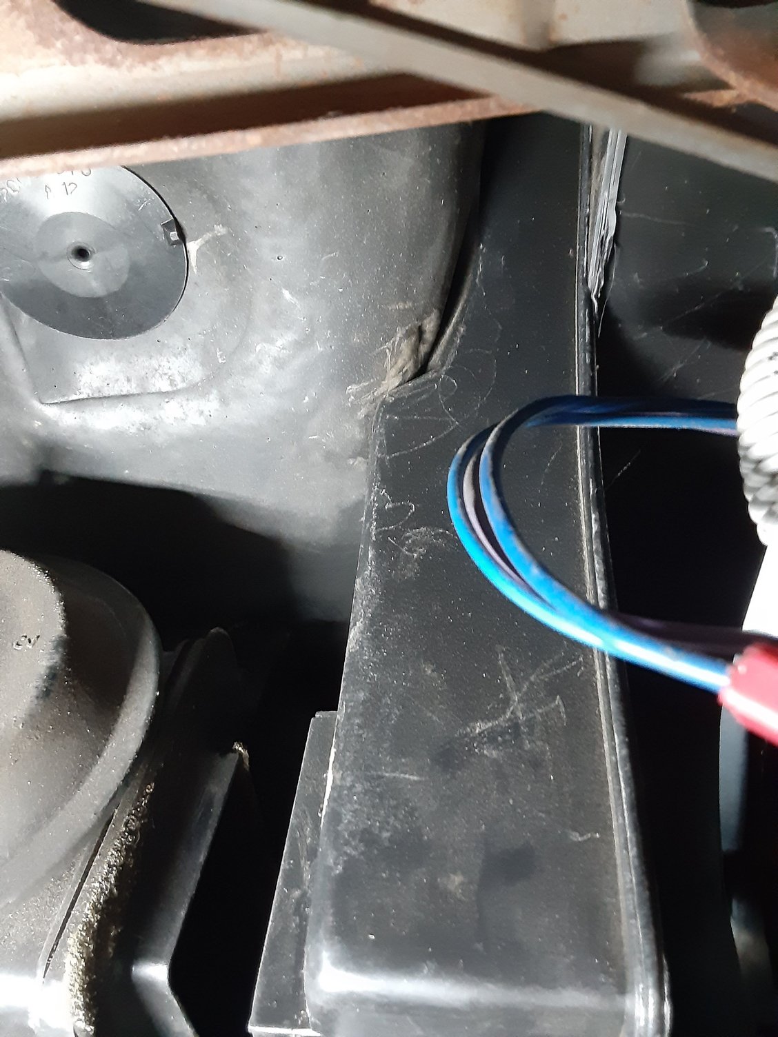 drivers side  looking up see rubber membrane stopping movement of dash side heater box toward firewall