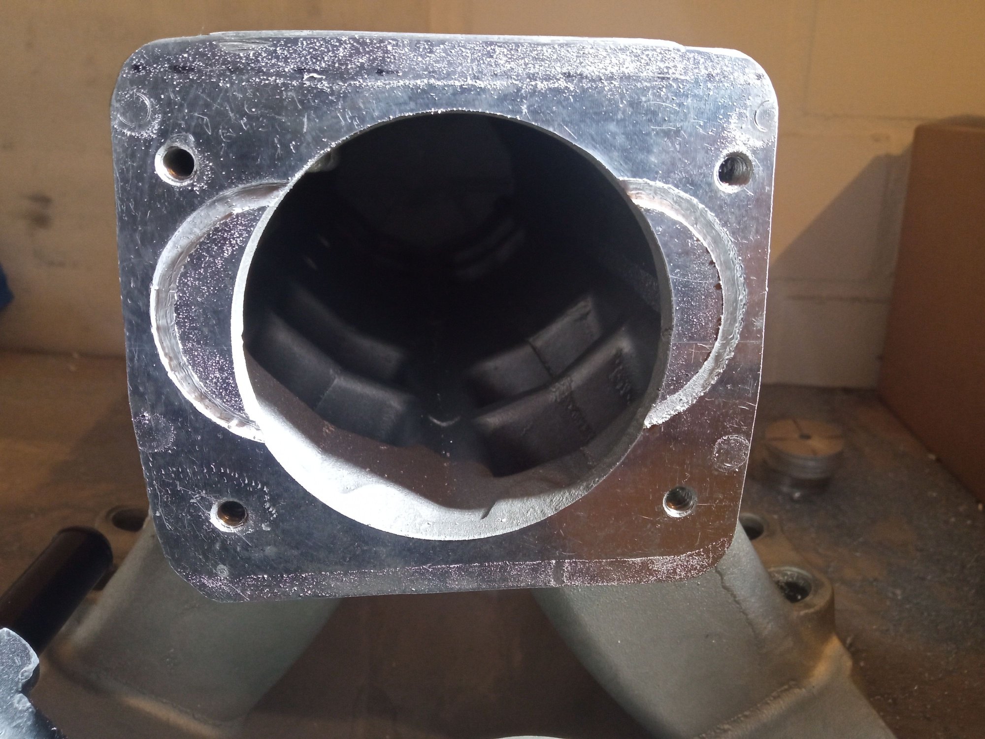 After drilling and tapping the adapter holes for the mounting of the body its critical to cut enough material off to provide the throttle blade movement and a smooth air transition. You can see where I was going to cut.