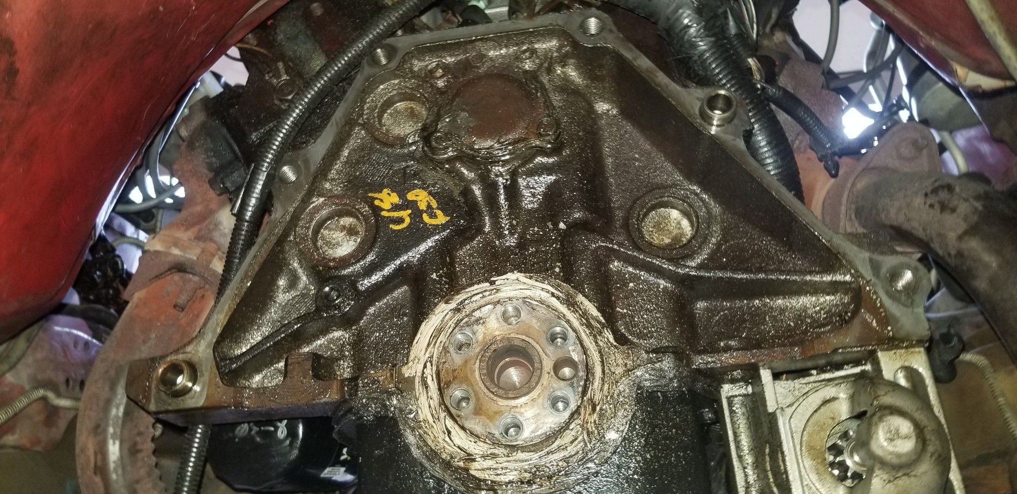 Heres a view where you can see the rear cam plate as well... also slathered in RTV.  Say hi to the junkyard markings too!  This motor was replaced at 100k back in like 2005, way before I bought the car.