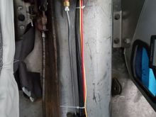 Factory parking brake lever mounted to floor just to the left of the brake proportioning valve.