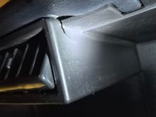 A small crack by the upper middle vents on the passenger side.