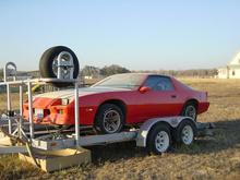How it looked when I first bought it.  It came with a disassembled 305 TBI out of a 1990 RS in it and a bunch of spare parts.  It came with a black hood off the RS as well, but I found the white early Z/28 one in the junkyard, but unfortunately the rust was too pervasive on it to save.