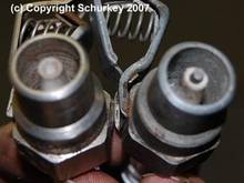 HEI style has recessed center electrode to make a longer spark gap.