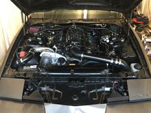 Pulled the coil and engine covers. Has a 165amp small case black powdercoated power master alt for clearance for stock hood.