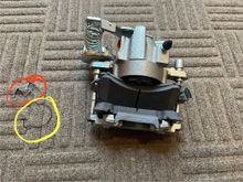 The red is the clip that came with the brake pads and the yellow is the clip that came off the old caliper. As you can see, the near pad stays somewhat in place but would be easy to take off while the far pad doesn't stay up at all.