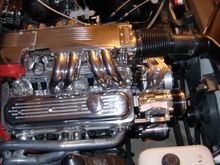 Billet Specialties, Ball-milled valve covers (no longer made).  Edelbrock headers with AIR tubes removed.