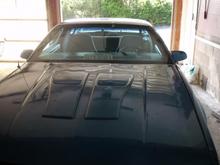 hood that has gone through a hailstorm