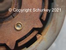 Magnet cracked on either side of the riveted area.