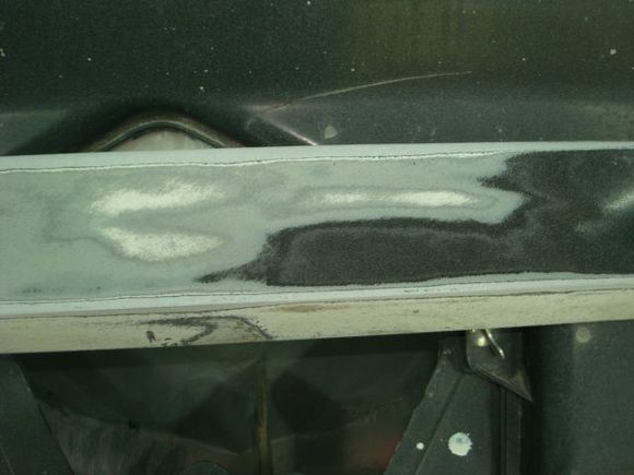 Sanding through paint layers on the door ground effect you can see the factory white, then the silver that Morrison Cook painted it and then black from whoever was the last to race it.