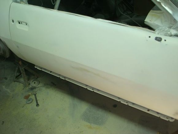 Started hand blocking the first layer of bondo and epoxy on the door and found a high area.