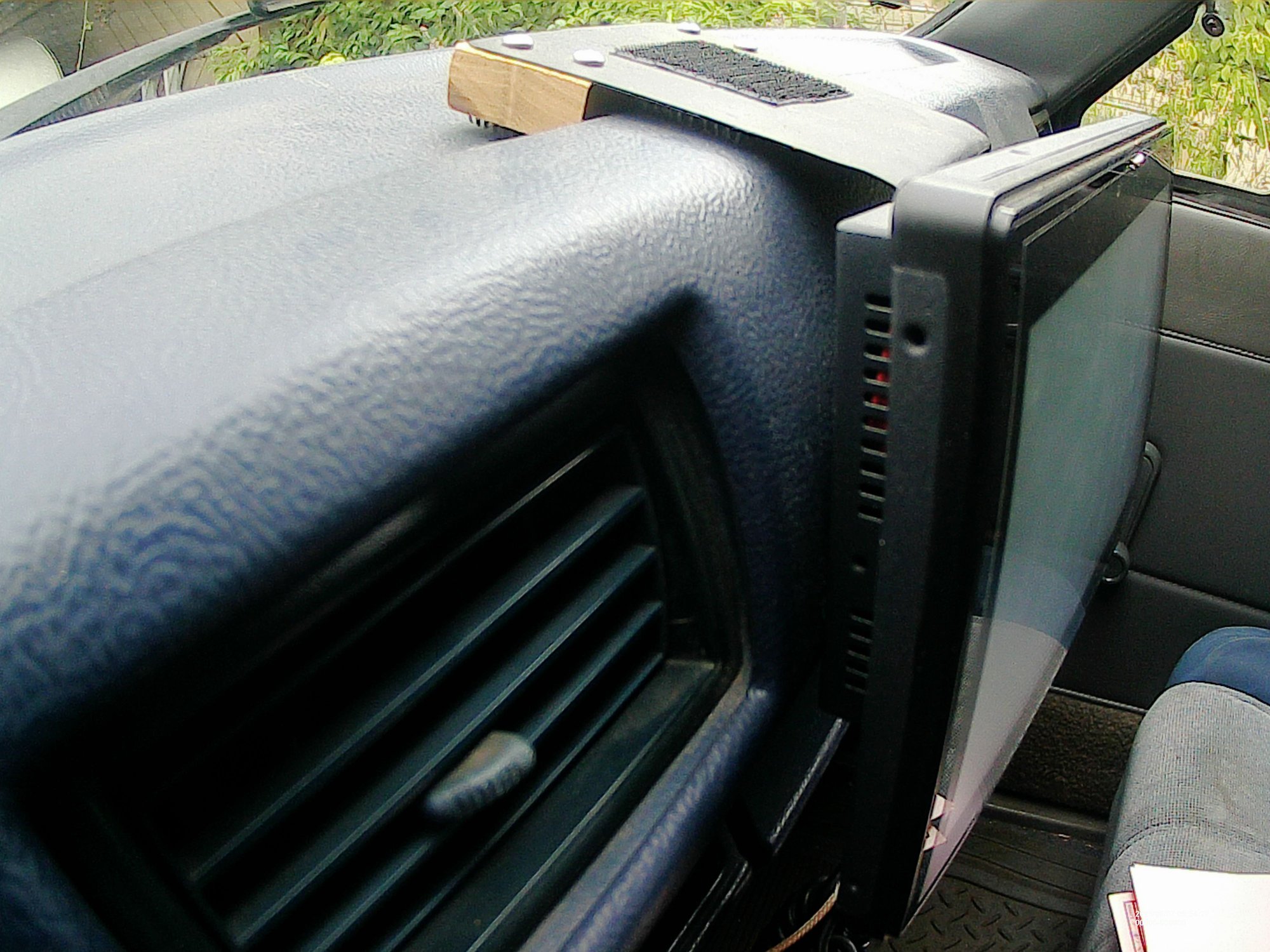 Velcro bracket. Far side of the screen is shimmed to angle towards the driver. 