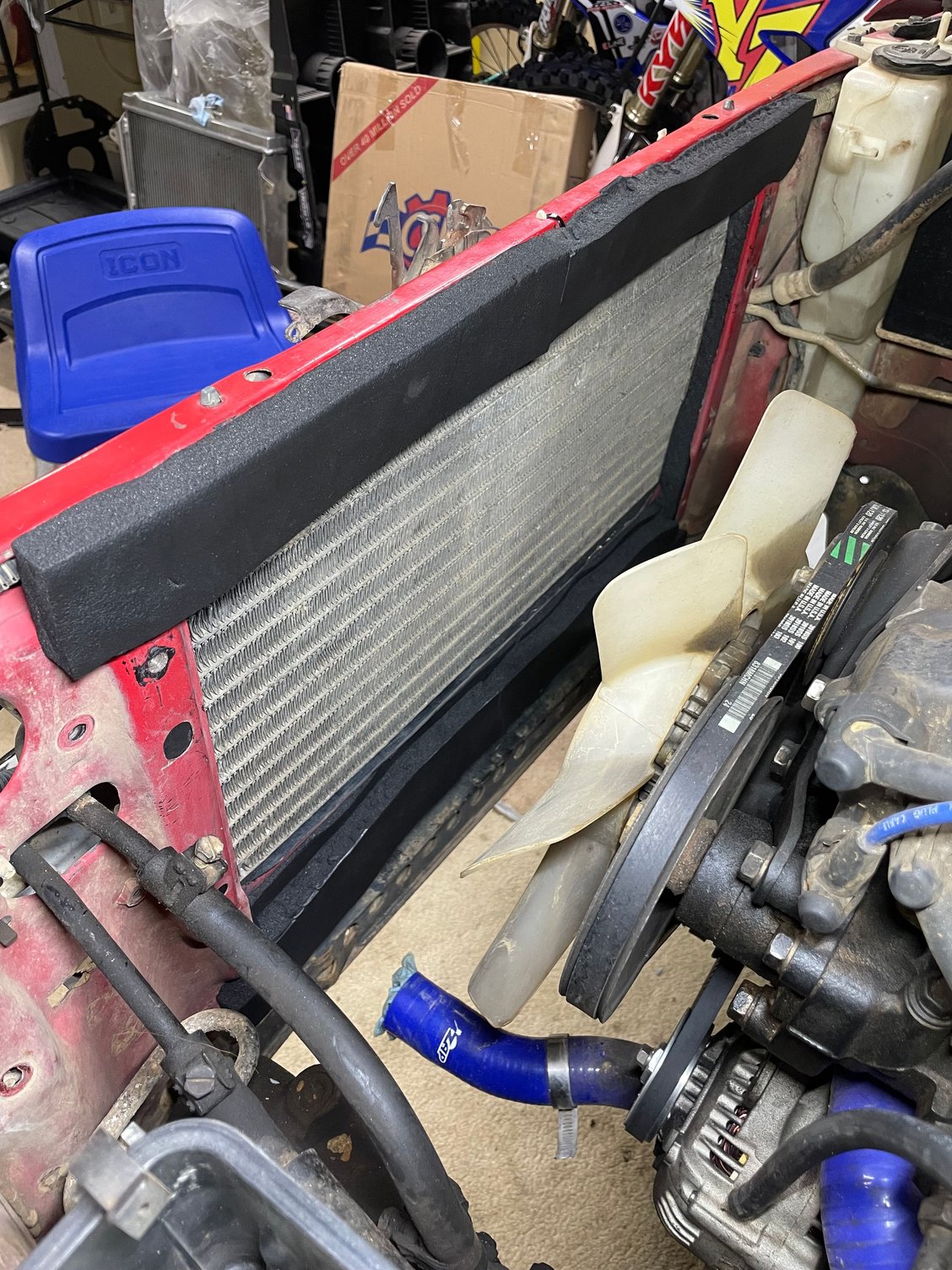 Before adding the thin grey vertical strips that seal the thin gaps of the radiator�s mounting flanges to the core support.