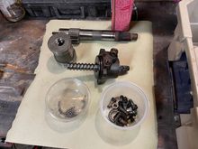 Unscrew the input shaft from the power piston. Bearings will fall out! Clean everything. Spray thru the valve control with Brakleen and make sure movement is smooth and not loose. If yours is leaking around the input shaft you will need to disassemble further to change the seal.