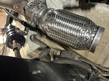 I clocked the 2.25" side of the adapter to one side when tacking it to the flex joint to provide an angle that pointed away from the frame and fuel lines