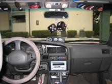 better view of the OEM altimeter/tilt gauge.   Also you can see the aftermarket pedals (Wal-Mart, $25) ProLock anti-theft (with the red lanyard attached) and 12V Cellphone charger/GPS adapter.  There's a compass behind the rear-view mirror ($3 Wal-Mart) and FastTrak, the Bay-Area automatic bridge toll radio thing.  Also note the MP3 player mounted in the ashtray.

Also, I slipped a small flat-blade eyeglass screwdriver on the sides of the plastic air vents to remove them, put them in the dishwasher (yeah i know but it was quick and effective) to clean them out.