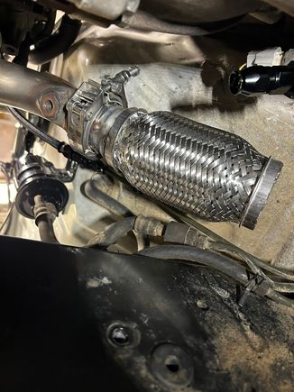 I clocked the 2.25" side of the adapter to one side when tacking it to the flex joint to provide an angle that pointed away from the frame and fuel lines