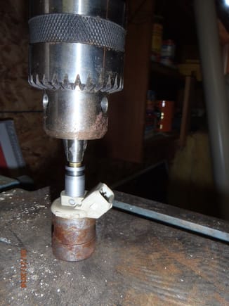 using drill press to install screen filter in injector