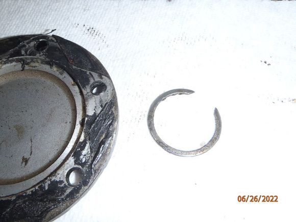 the snap ring that holds the brake portion of the locking hub system to the stub axle. use a small flat-blade screwdriver to pry this off of the stub axle