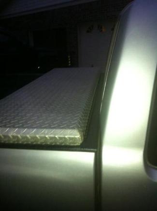 When I first got the truck the toolbox was too far up and it would hit against the back of the cab, and not open all the way.  When I got around to scooting it back, there was a little bit of a gap in the bed.